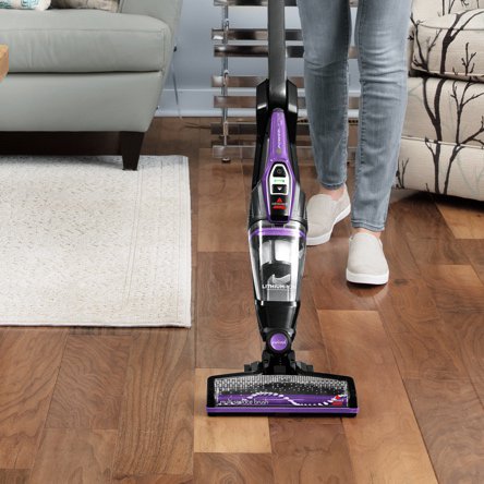 A vacuum cleaning hard floors and cleaning carpets showcasing which vacuums are best for multi-surface homes. Links to a blog post about which vacuums are best for cleaning hard floors and carpets
